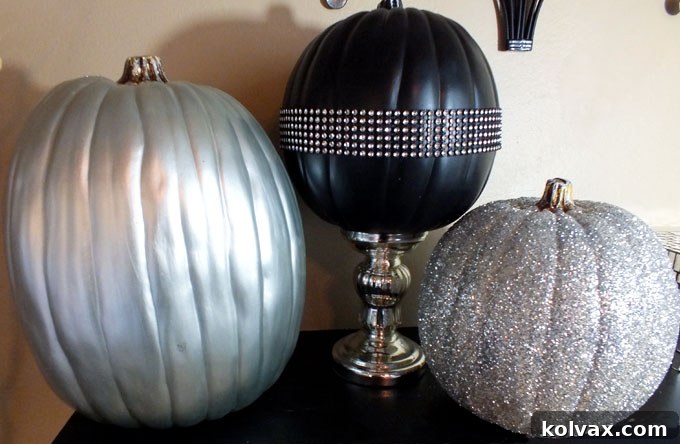 A trio of elegant black and silver pumpkins, handcrafted with care