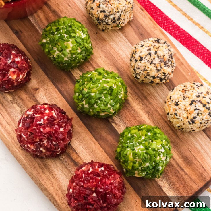 Golden Cheese Puffs 8 Cheese Ball Bites, perfectly rolled and topped with festive garnishes, presented on a serving platter.