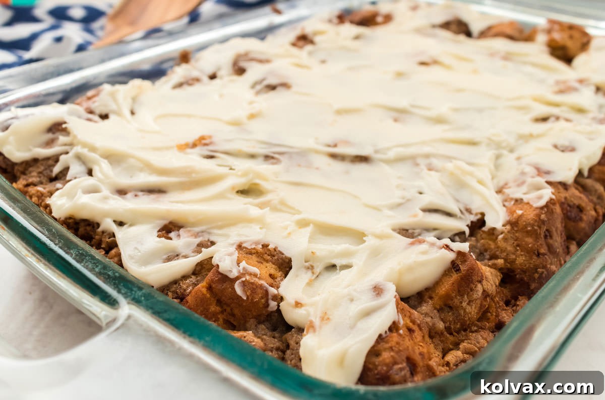 Close up of a pan of Cinnamon Roll Breakfast Casserole covered with a thick layer of Cream Cheese Frosting.