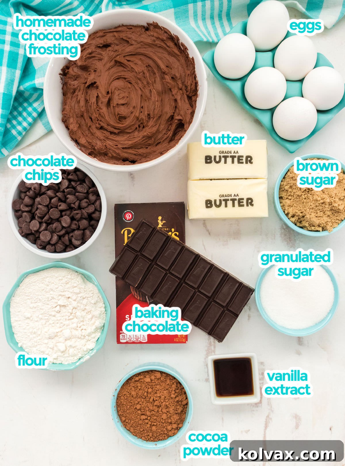 Heavenly Frosted Brownies 3 All the necessary ingredients for baking indulgent frosted brownies are neatly displayed, including high-quality chocolate for melting, chocolate chips, cocoa powder, flour, sugar, eggs, butter, and vanilla extract, alongside components for the decadent chocolate frosting.