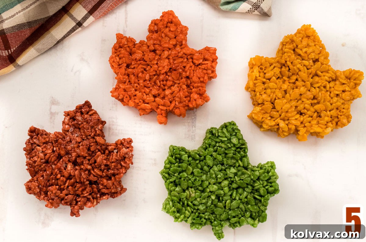 Autumn Foliage Rice Krispie Bars 7 A vibrant display of four different colors of Fall Leaves Rice Krispie Treats: Sage Green, Burnt Orange, Gold, and Red/Brown, showcasing their rich autumn hues.