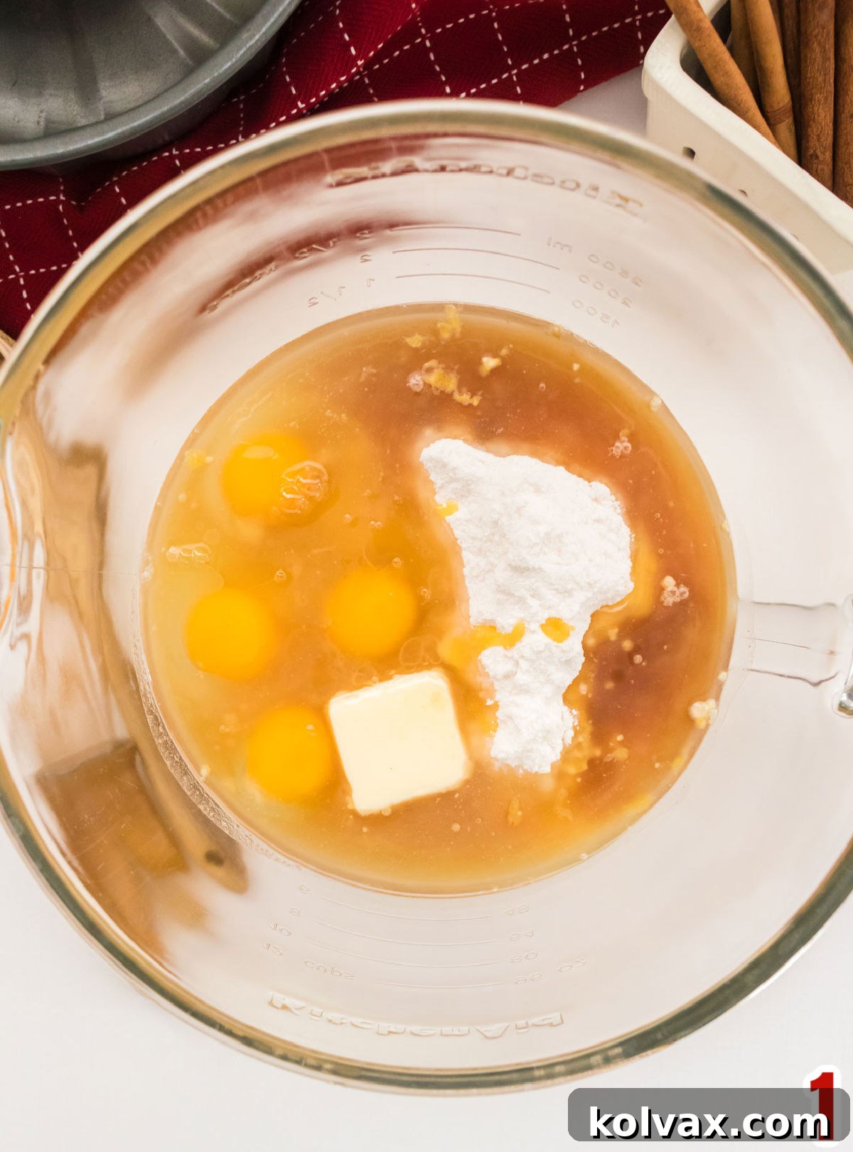 Yuletide Morning Coffee Cake 4 A close-up view of a glass mixing bowl brimming with the combined ingredients for the Christmas Morning Coffee Cake batter, ready for mixing.