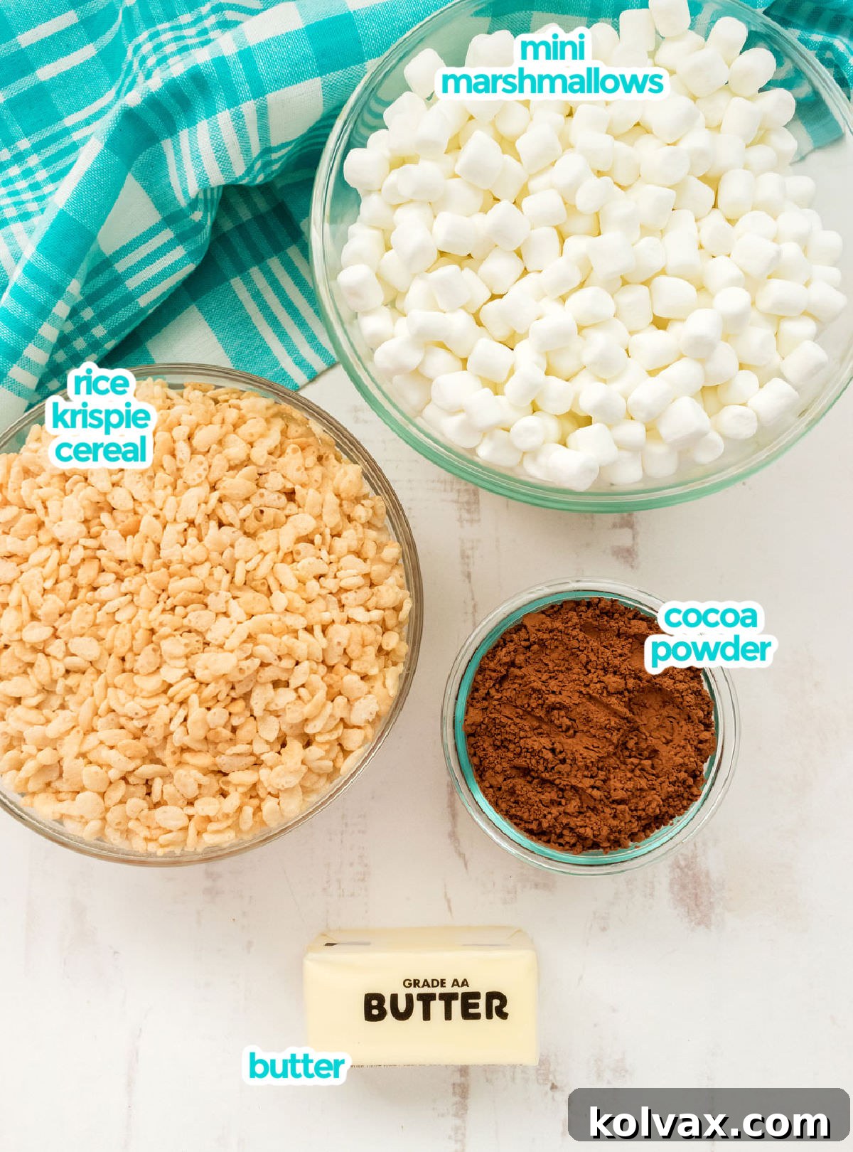 All the ingredients you will need to make Chocolate Rice Krispie Treats including Mini Marshmallows, Rice Krispie Cereal, Butter and Cocoa Powder.