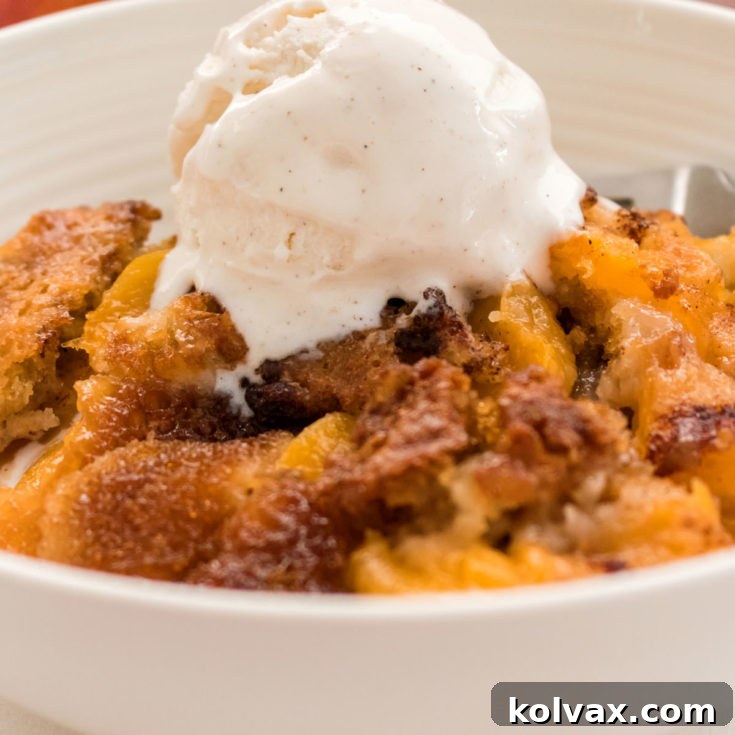 A beautifully presented bowl of Old Fashioned Peach Cobbler, warm and inviting, perfect for sharing.
