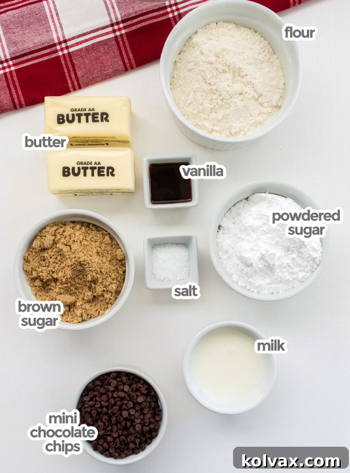 All the ingredients you will need to make Edible Cookie Dough including heat-treated flour, softened butter, vanilla extract, powdered sugar, brown sugar, milk, and a bowl of Mini Chocolate Chips.