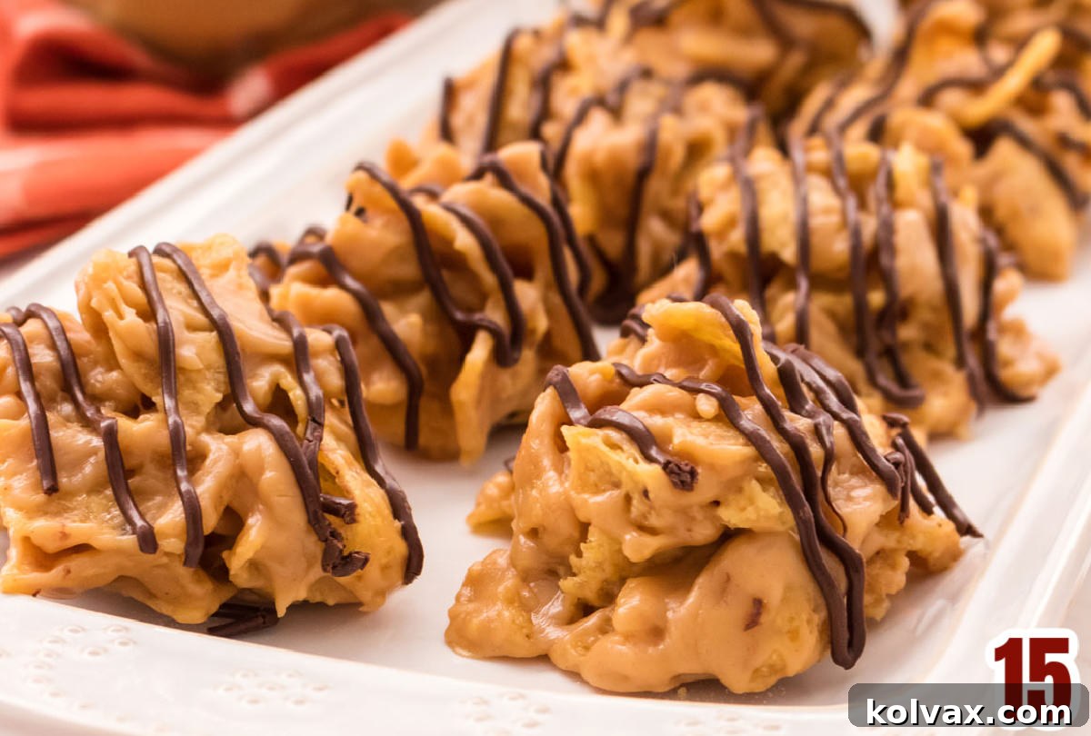 A close-up shot of eight perfectly formed and decorated Corn Chip and Peanut Butter No Bake Cookies arranged on a white serving platter.