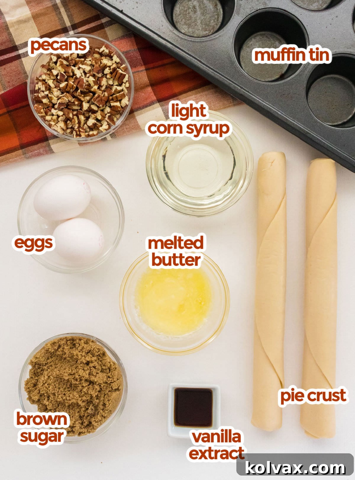 All the ingredients needed for Mini Pecan Pies, including chopped pecans, light corn syrup, melted butter, eggs, vanilla extract, brown sugar, and pre-made pie crusts, neatly arranged.