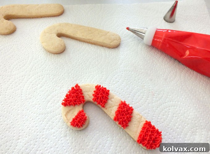 Assortment of cookie decorating tools including piping bags, frosting tips, and toothpicks on a table