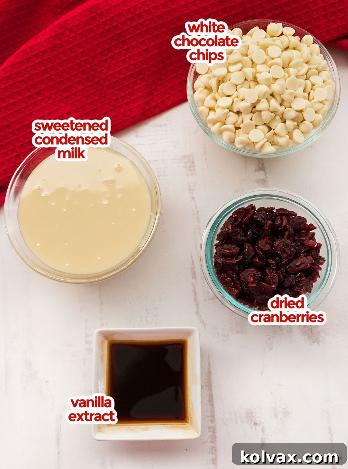 All the ingredients you will need to make White Chocolate Cranberry Fudge including White Chocolate Chips, Sweetened Condensed Milk, Dried Cranberries and Vanilla.