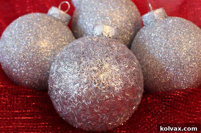 Sparkling Silver Christmas Tree Baubles 2 Stunning handmade silver glitter Christmas tree ornaments shimmering on a festive Christmas tree, perfect for an easy DIY Christmas craft project.