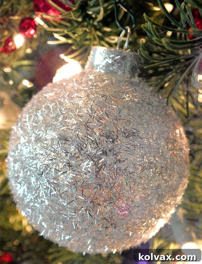 Sparkling Silver Christmas Tree Baubles 6 Beautiful handmade silver glitter Christmas ornaments hanging to dry, showcasing their sparkle and readiness for festive holiday display.