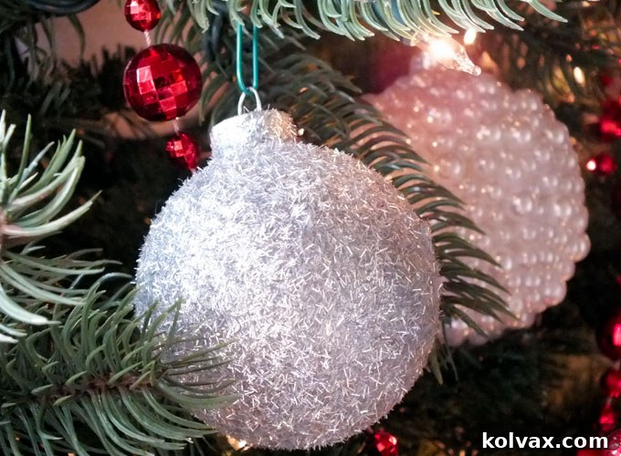 Sparkling Silver Christmas Tree Baubles 8 Another silver glitter Christmas ornament, showcasing a different type of glitter for varied textures and reflectivity.