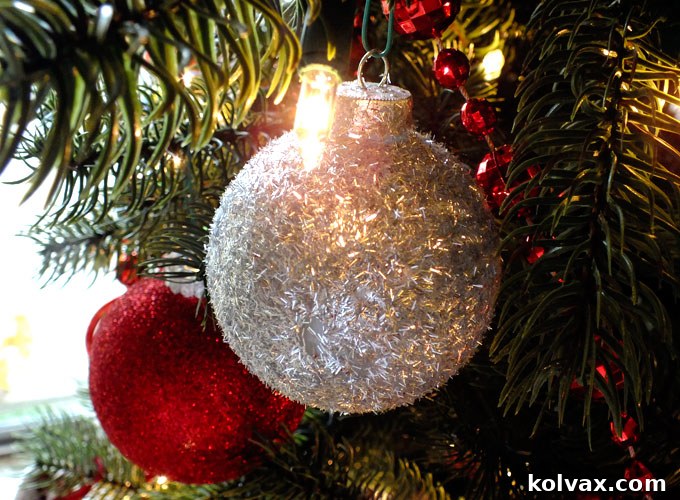 Sparkling Silver Christmas Tree Baubles 9 A collection of handmade silver glitter Christmas tree ornaments arranged beautifully, highlighting their impact as a Christmas craft project.