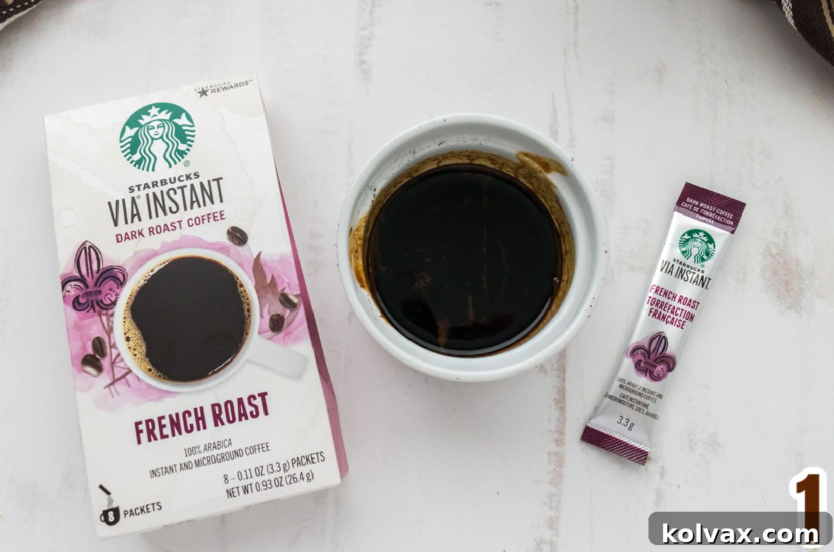 Velvet Coffee Buttercream 3 A small white ramekin filled with dark roast instant coffee granules and vanilla extract, ready to be steeped.