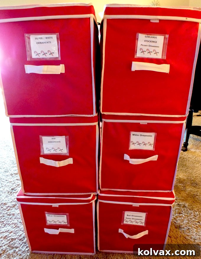 Organized Christmas tree ornaments, sorted by color in soft-sided storage containers, ready for decorating.