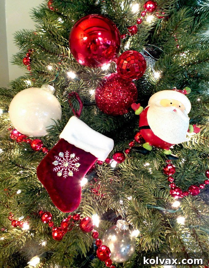 A creative ornament grouping featuring a Santa, a Christmas stocking, a fancy white ornament, and three red ornaments on a single hook.
