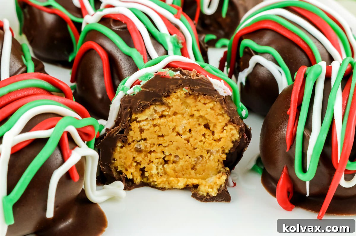 Closeup on a batch of Christmas Peanut Butter Crunch Truffles on a white plate, the one in the center is cut in half.