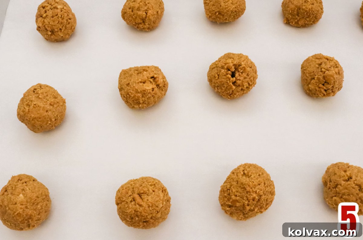 Overhead shot of the peanut butter candy balls sitting on a cookie sheet.