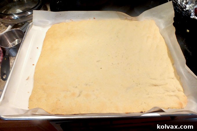 Baked Frozen Sugar Cookie Bars with a very light golden brown edge, indicating they are perfectly cooked and ready for cooling.