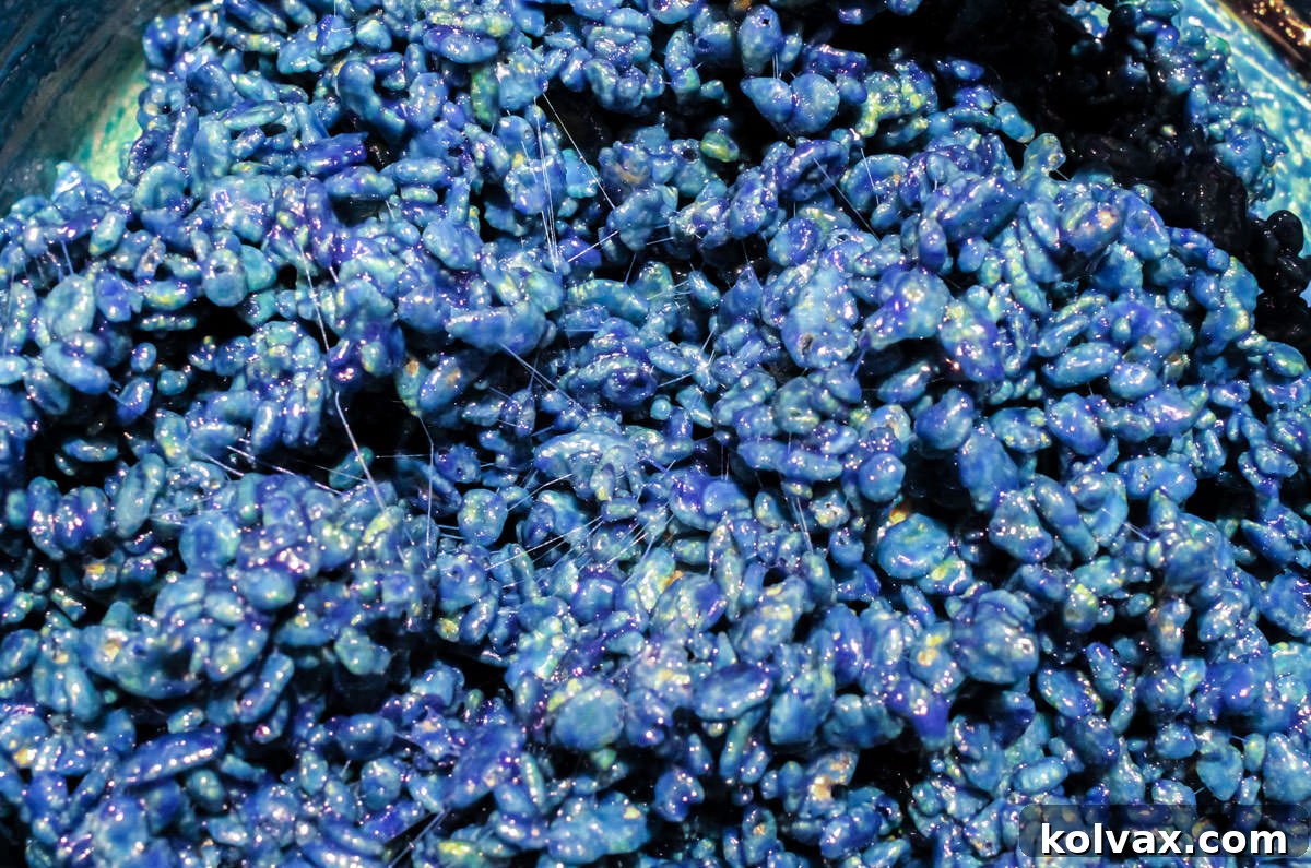 Close up on a pan filled with Navy blue Rice Krispie Treats mixture.