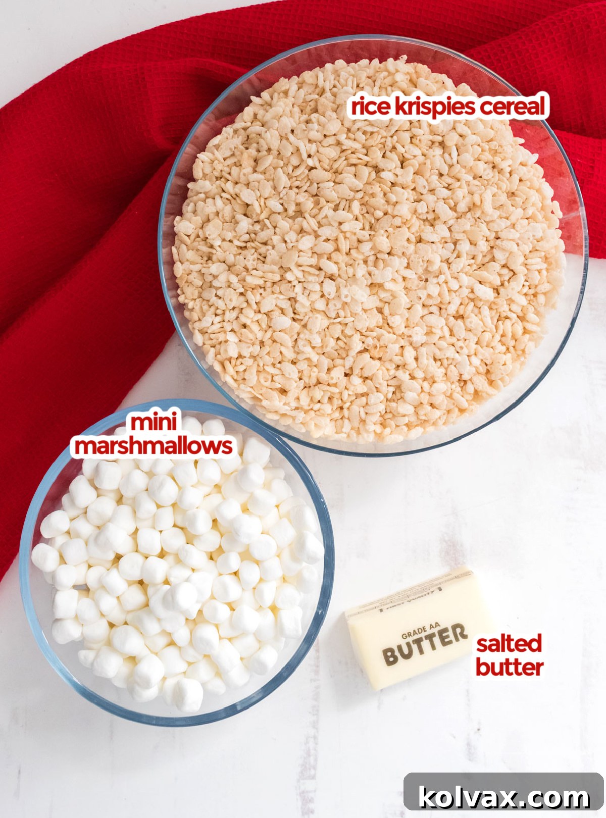 A visual guide displaying all the essential ingredients laid out neatly for making Toasted Marshmallow Rice Krispie Treats, including butter, mini marshmallows, and rice cereal.