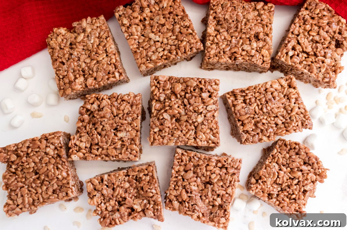 Overhead shot of a batch of Nutella Rice Krispie Treats laying on a white table in front of a red kitchen towel.
