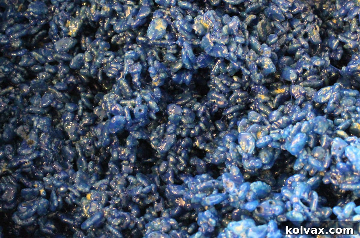 A close-up shot of a pan filled with the perfectly colored Navy Blue Rice Krispie Treat mixture, ready for molding.