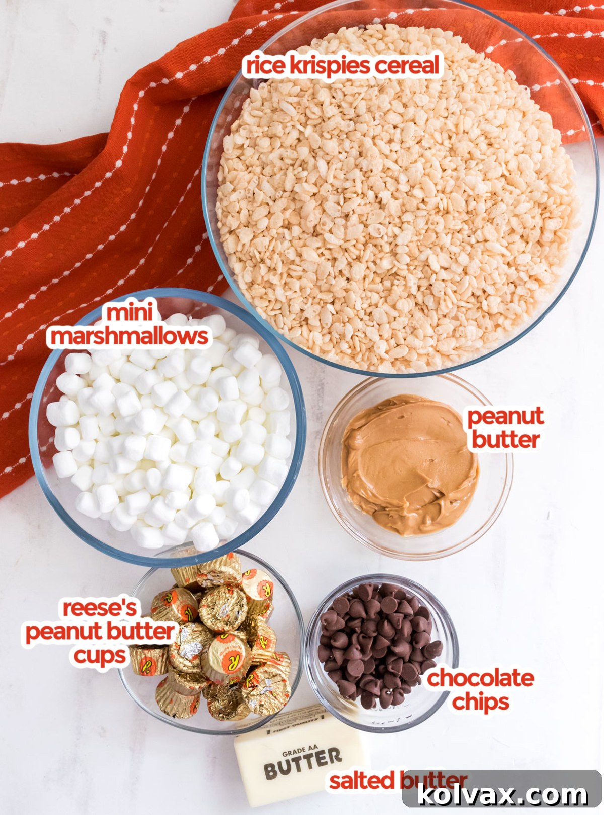 All the essential ingredients neatly laid out to make Peanut Butter Cup Rice Krispie Treats, including butter, marshmallows, peanut butter, Rice Krispies cereal, and Reese's Peanut Butter Cups.