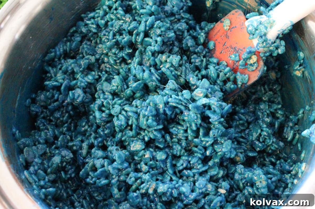 Closeup on a medium pan filled with blue Rice Krispie Treat mixture.