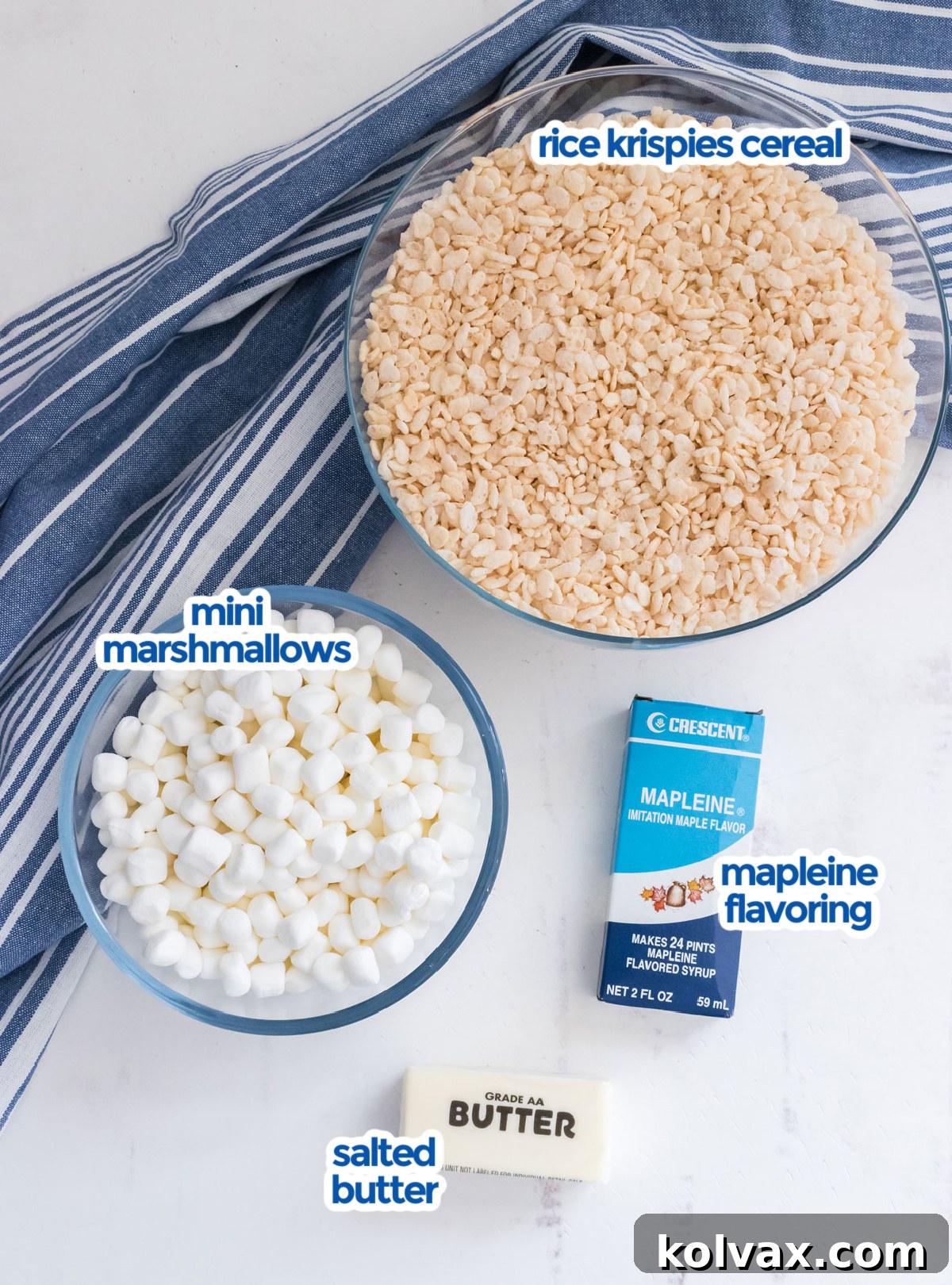 All the essential ingredients neatly arranged on a counter, ready to be combined for making Maple Rice Krispie Treats, including butter, marshmallows, maple flavoring, and Rice Krispies cereal.