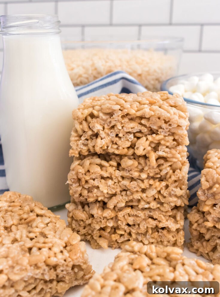 A decorative image for Pinterest promoting Maple Rice Krispie Treats recipe.