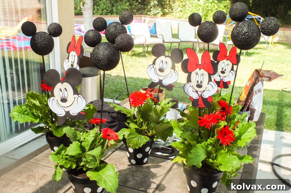 DIY Mickey and Minnie Mouse centerpieces made from painted terra cotta pots and styrofoam ears.