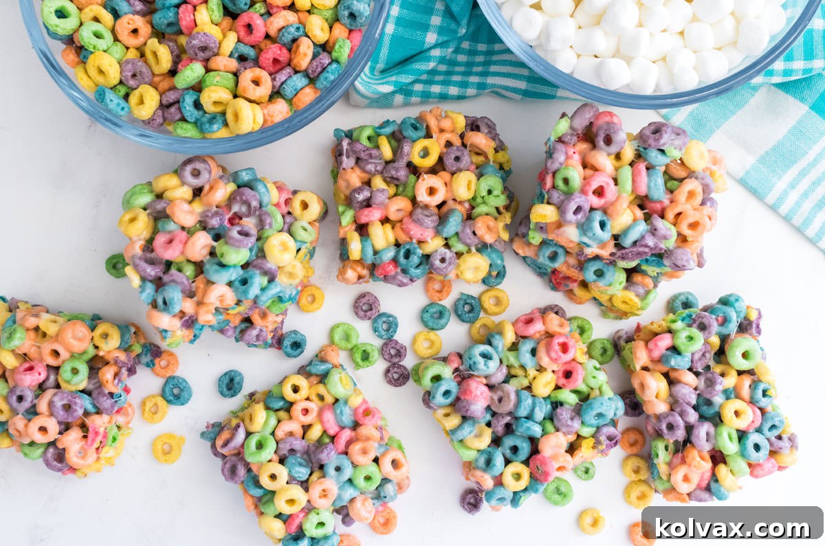 Overhead shot of a batch of Froot Loops Marshmallow Treats laying on a white table.