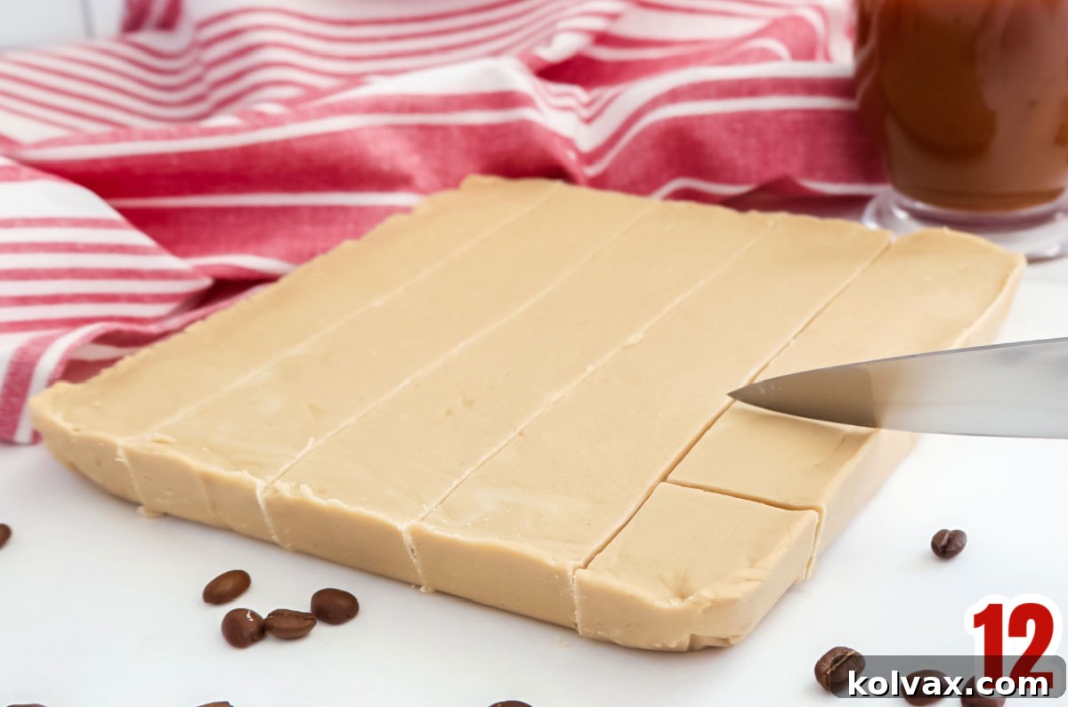 Close up on Coffee Fudge being cut into individual pieces on a white table using a knife.