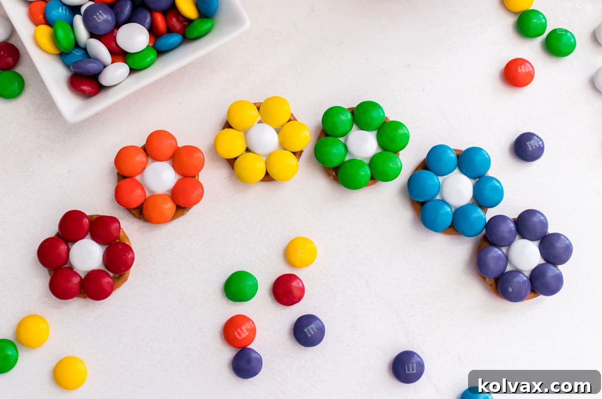 Closeup on a white table covered with a Red, Orange, Yellow, Green, Blue and Purple Flower Pretzel Bite.