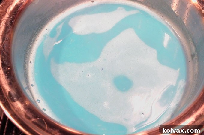 Adding a few drops of Americolor Royal Blue food coloring to the vanilla milk mixture.