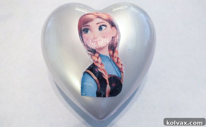 Warmth for the Winter Heart 12 Applying a cutout character image onto a painted heart with Mod Podge