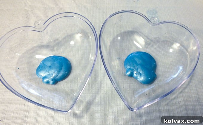 Warmth for the Winter Heart 5 Shaking the closed plastic heart ornament to spread paint inside