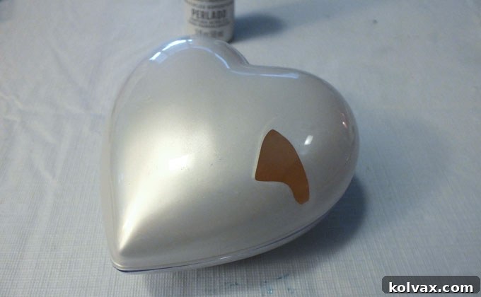 Warmth for the Winter Heart 10 Shaking the plastic ornament to cover the inside with Mother of Pearl paint