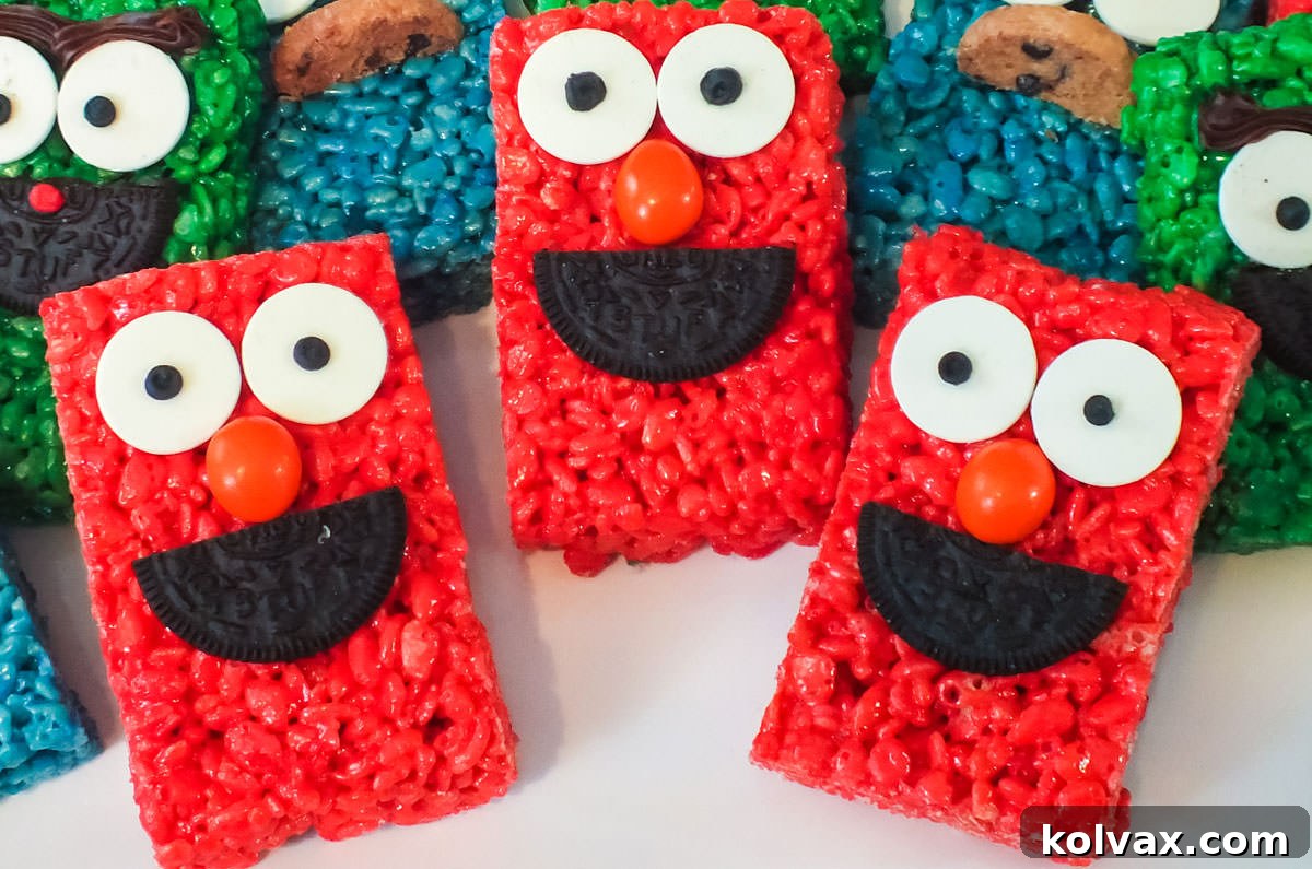 Closeup on three vibrant red Elmo Rice Krispie Treats artfully arranged on a pristine white serving platter, with additional treats softly blurred in the background, ready for an Elmo themed party.