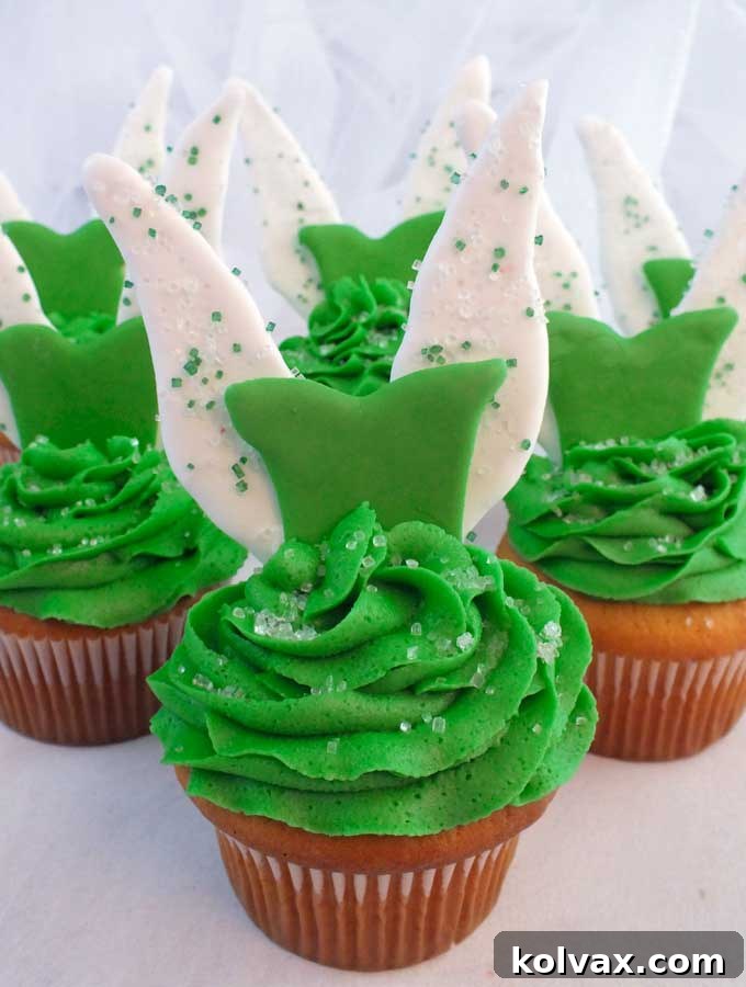 A close-up of beautifully decorated Tinkerbell Cupcakes, shining with fairy magic.