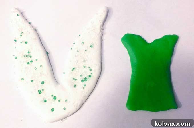 Finished royal icing Tinkerbell dress and wing toppers drying.