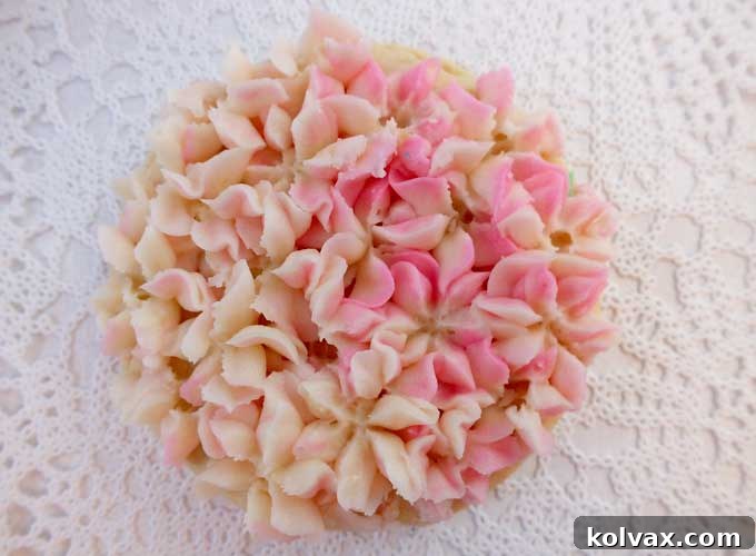 Whimsical Hydrangea Sugar Cookies 10 A beautifully decorated pink and ivory Hydrangea Frosted Sugar Cookie, showcasing a full blossom