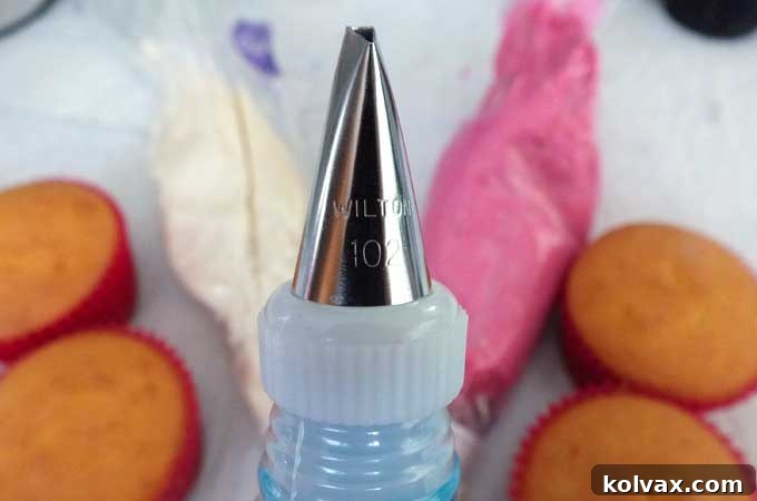 Close-up of a Wilton #102 Decorating Tip, essential for creating beautiful petal and ruffle effects on cupcakes.