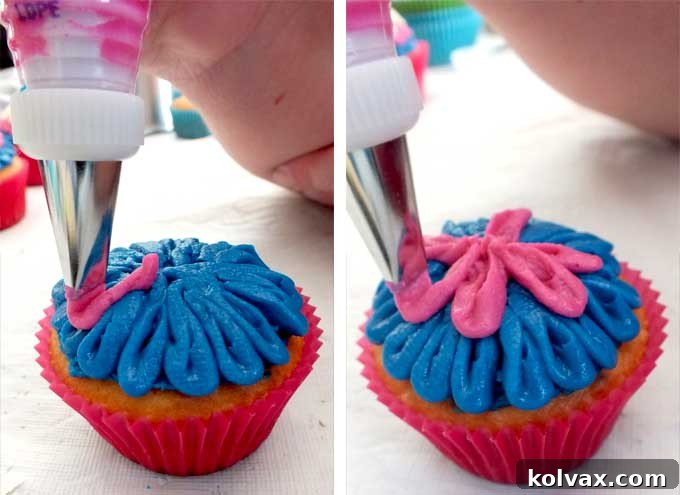 Detailed image demonstrating the petal piping technique for decorating Frozen Anna Cupcakes, showing the first layer of blue frosting.