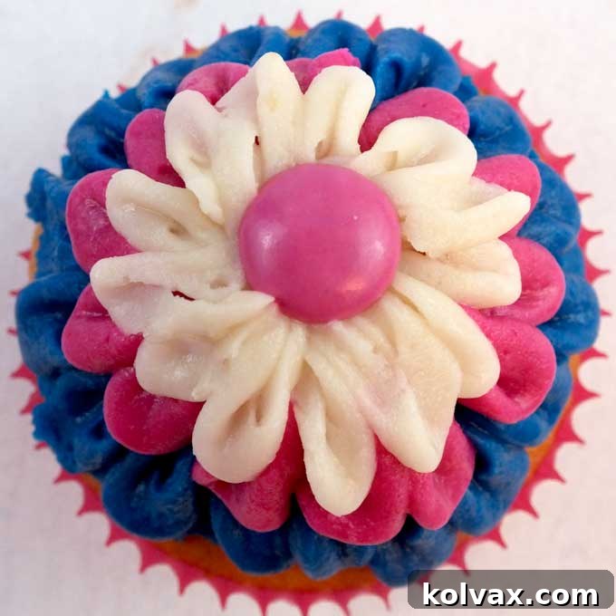 These Frozen Anna Cupcakes are adorable and delicious, featuring beautiful blue and pink ombre frosting. Perfect for a Frozen Party Dessert Table, this image highlights their appeal and provides inspiration for your next event.