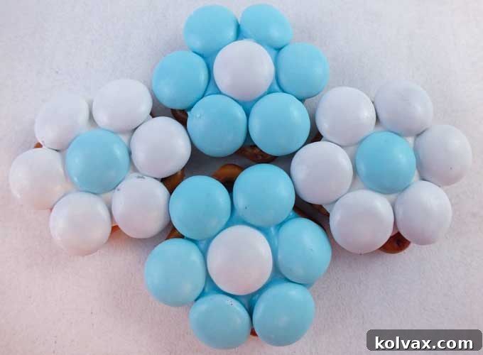 Our Elsa Pretzel Bites are the perfect sweet and salty treat for a Frozen Birthday Party and will look amazing on your Frozen Party Dessert Table. So pretty, so yummy and so easy to make. Follow us for more fun Frozen Party Ideas.