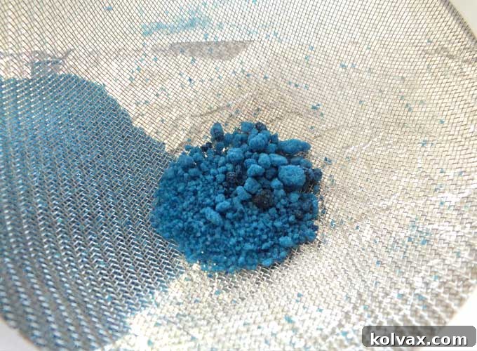 Sifting the Finished Homemade Blue Sparkling Sugar for Even Texture