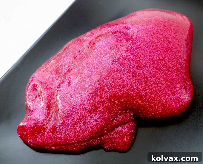 Our Anna's DIY Glitter Slime is beautiful and sparkly homemade GAK for a Frozen Birthday Party or that Princess Anna fan in your life. Easy to make and great for a party activity or as party favors for the kids we have step by step directions on how to make this fun and colorful sensory activity for kids. Follow us for more fun Frozen Party Ideas.