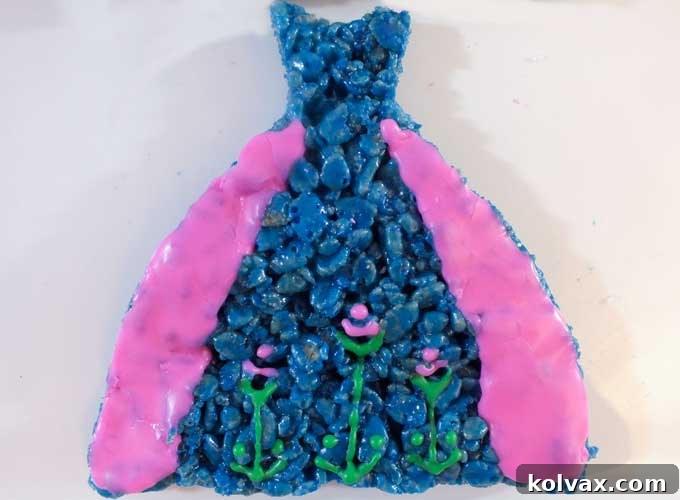 Anna's Dress Rice Krispie Treats are decorated to look like Princess Anna's iconic blue and pink dress and are great for a Frozen Birthday Party. They will be a hit at your Frozen Party and we have the step by step directions you'll need to make them for your own Frozen Party. Follow us for more fun Frozen Party Ideas. 